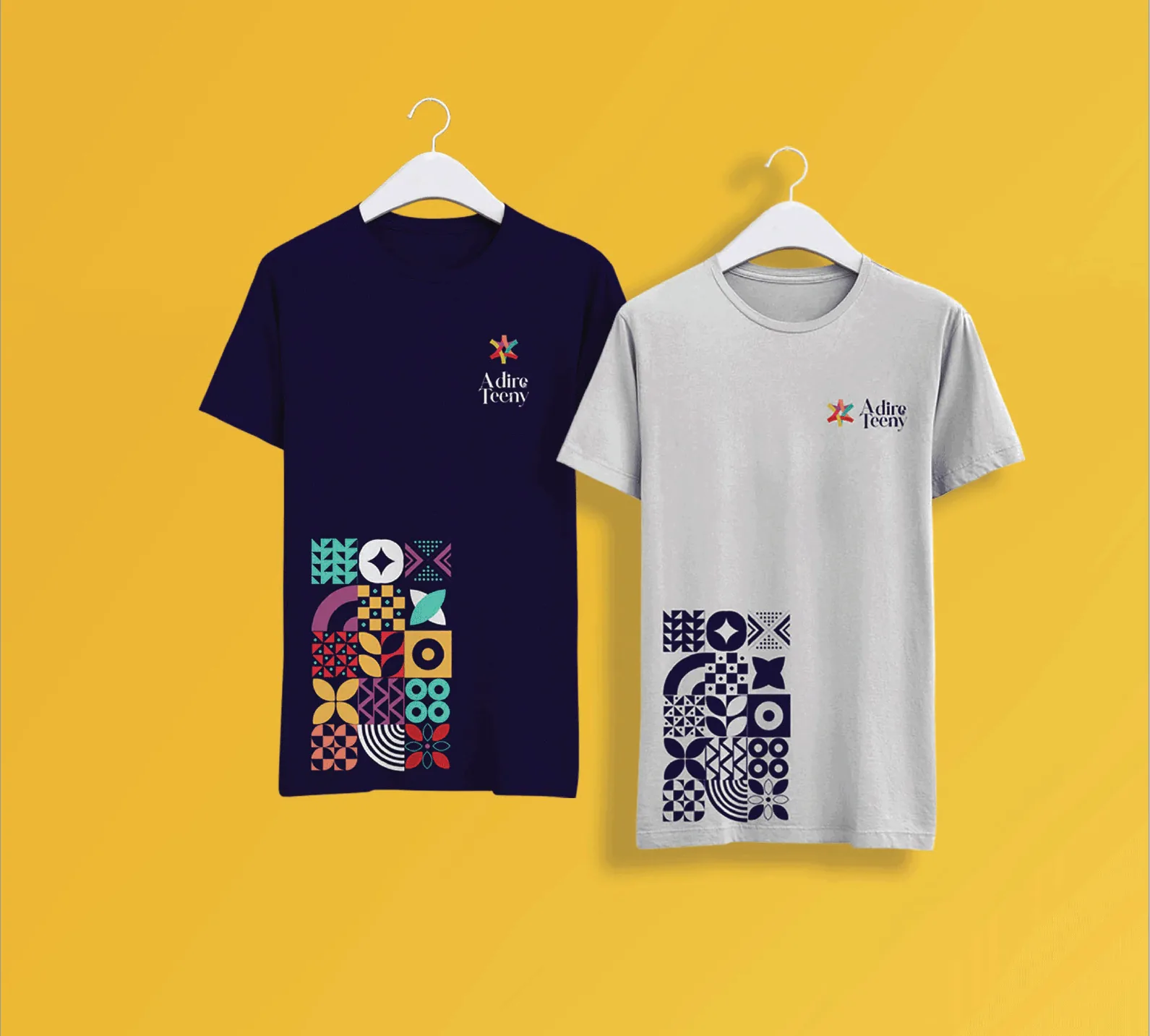 Indigo and grey T-shirts on hangers with the star logo on the chest and a block of pattern tiles on the hem